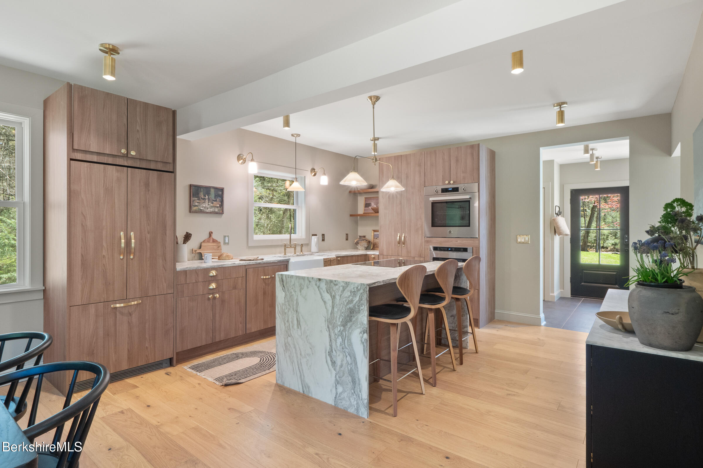 246 County Road Sheffield, MA 01257 - Photo 29 of 59 a kitchen with stainless steel appliances kitchen island granite countertop a refrigerator a stove a sink a dining table and chairs with wooden floor