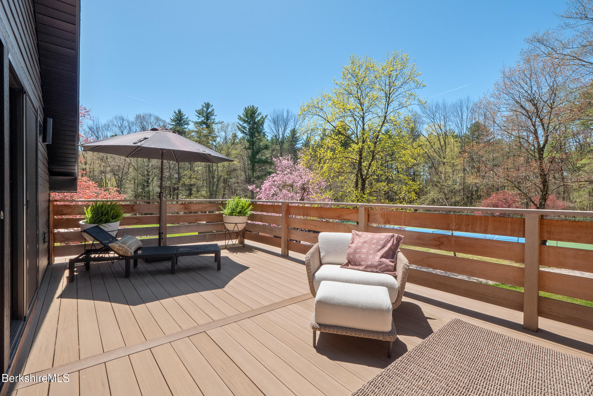 246 County Road Sheffield, MA 01257 - Photo 50 of 59 a view of a patio with couches and table and chairs with wooden floor and fence
