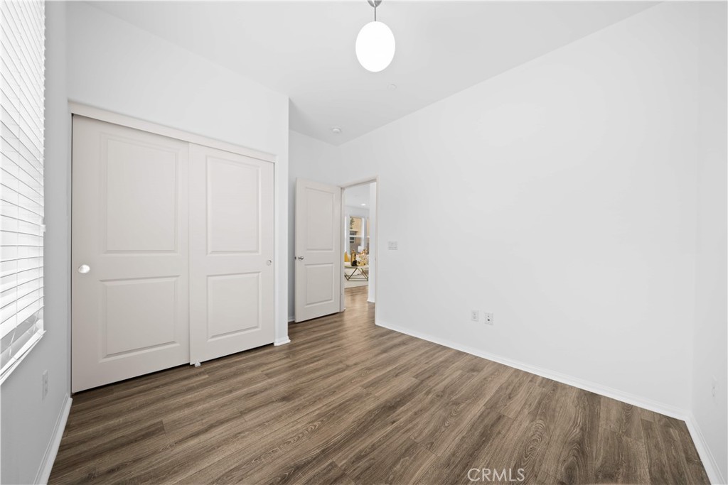 145 Mongoose Irvine, CA 92618 - Photo 17 of 37 an empty room with wooden floor and windows