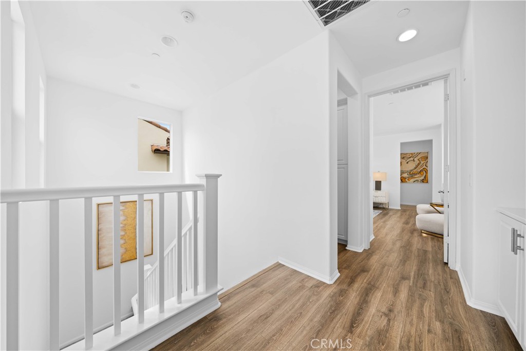 145 Mongoose Irvine, CA 92618 - Photo 19 of 37 a view of a hallway with wooden floor and a living room