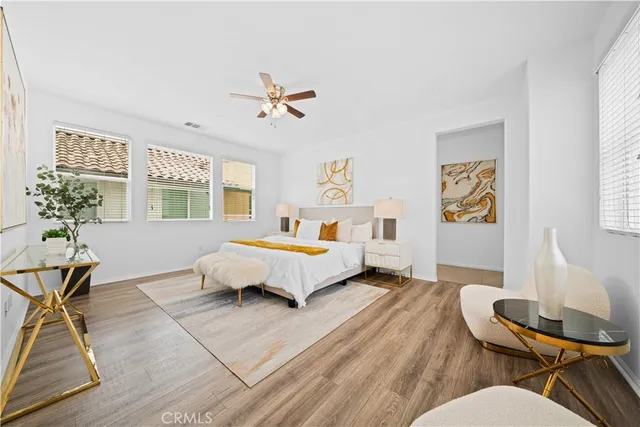 a bedroom with a bed and a potted plant
