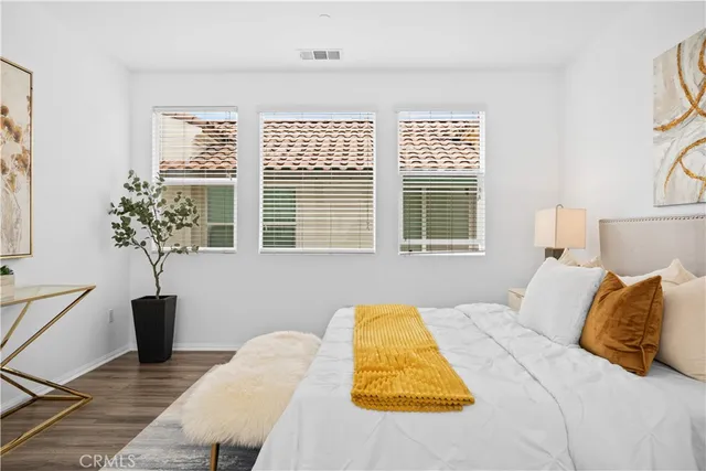 a bedroom with a bed and a potted plant