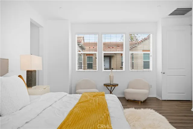 a bedroom with a bed and painting on the wall