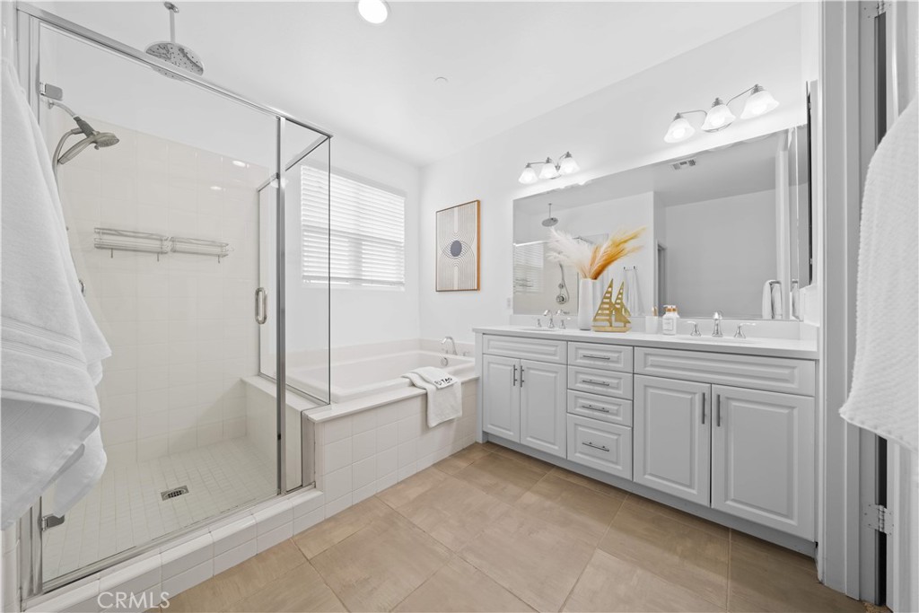 145 Mongoose Irvine, CA 92618 - Photo 29 of 37 a bathroom with a granite countertop sink a mirror a shower and a bathtub