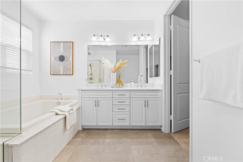 145 Mongoose Irvine, CA 92618 - Photo 30 of 37 a spacious en suite bathroom with a granite countertop tub and a sink