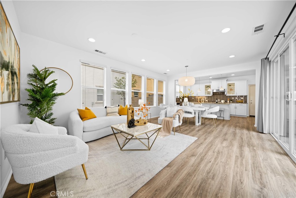 145 Mongoose Irvine, CA 92618 - Photo 7 of 37 a living room with furniture and wooden floor