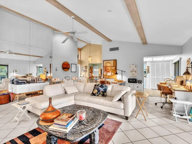 a kitchen with stainless steel appliances granite countertop a refrigerator a stove a sink dishwasher and white cabinets with wooden floor