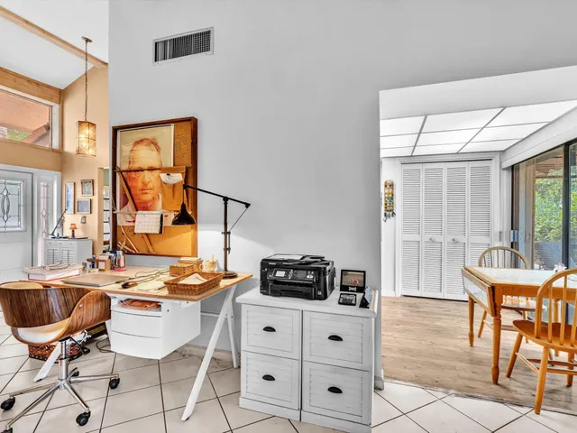a view of a livingroom with furniture and a dining table