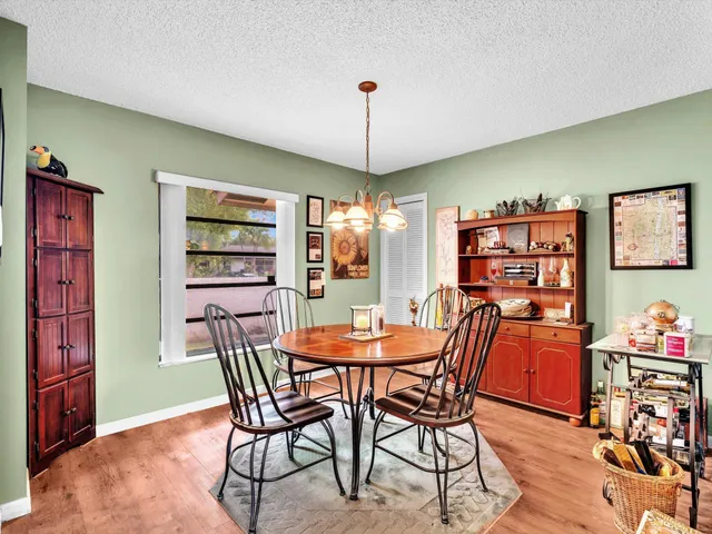 a large bedroom with a large bed and a flat tv screen on dresser
