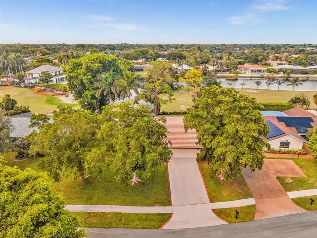 a front view of a house with yard and green space