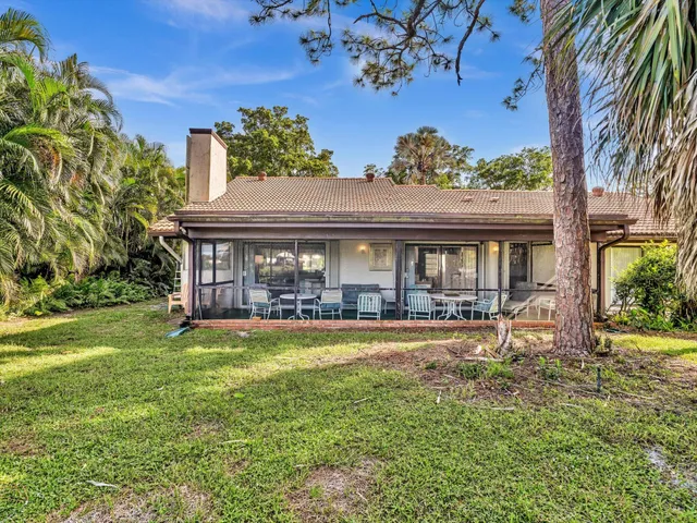 an aerial view of a house with a yard swimming pool and garden
