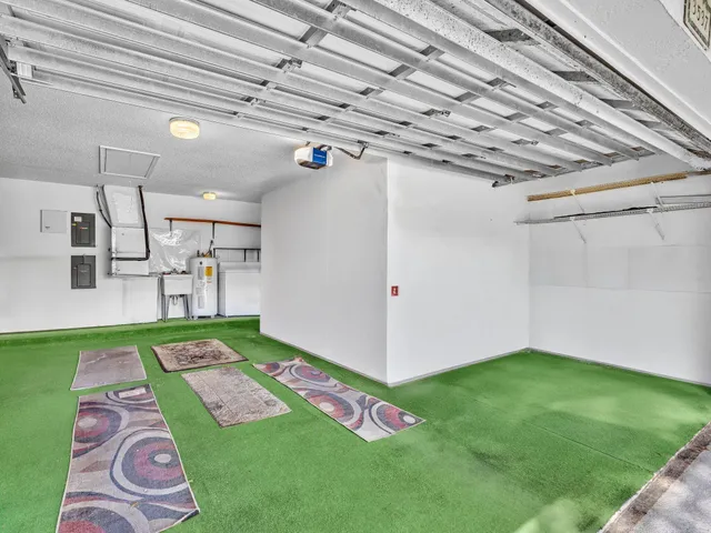 a front view of multi story residential apartment building with yard and outdoor seating