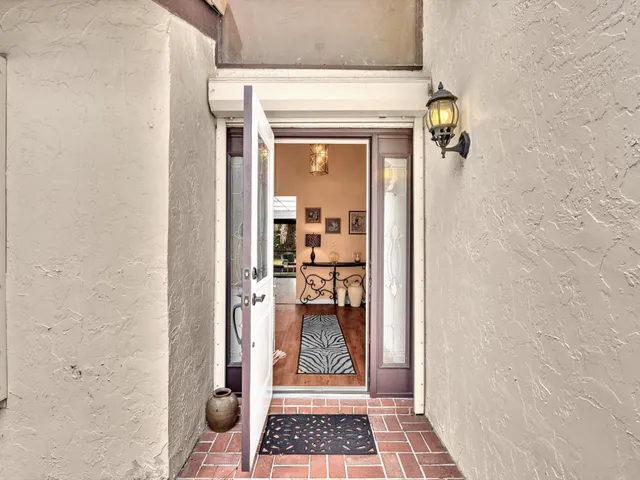 a living room with furniture a large window and a fireplace