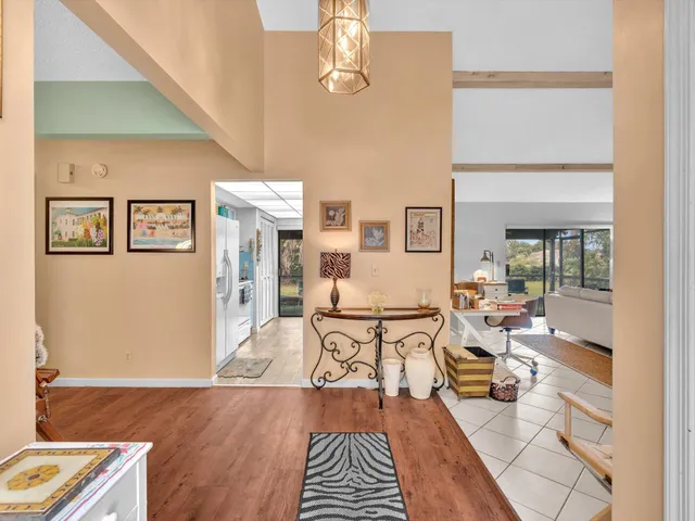 a living room with furniture a fireplace and a large window