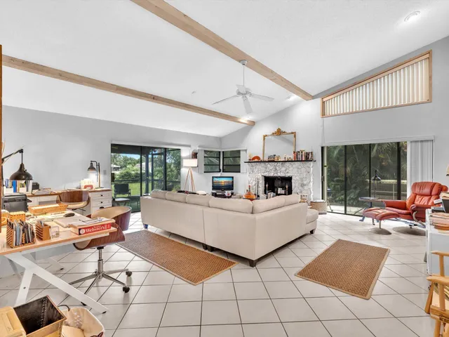 a living room with furniture large window and a table