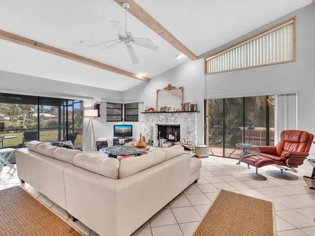 a living room with furniture a rug and white walls