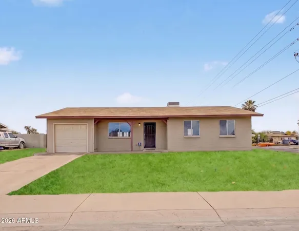 a front view of house with a garden