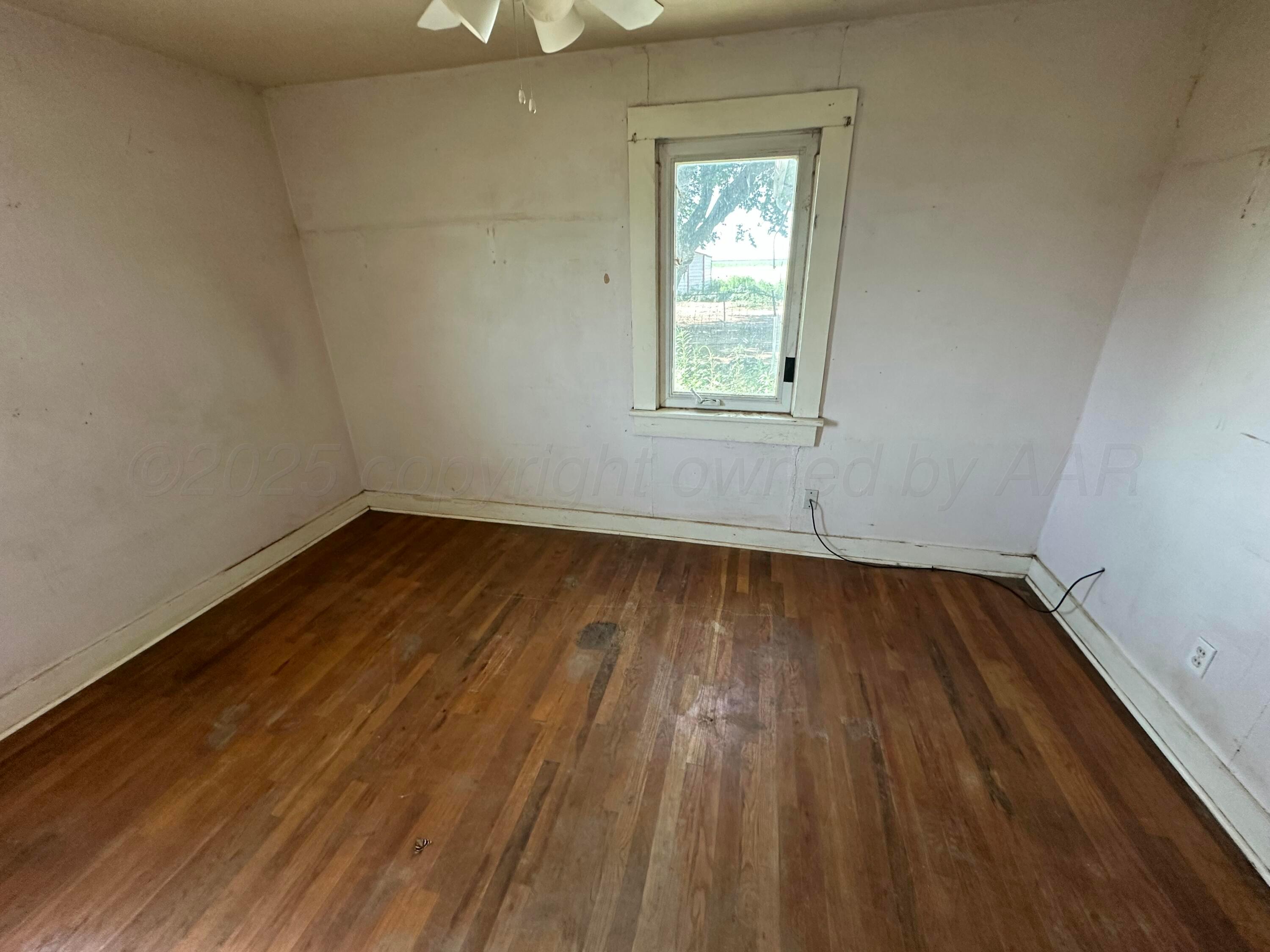 1381 Fm 293 Road Panhandle, TX 79068 - Photo 7 of 12 a view of a room with wooden floor and window