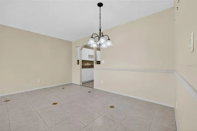 a view of a kitchen with dishwasher and white cabinets