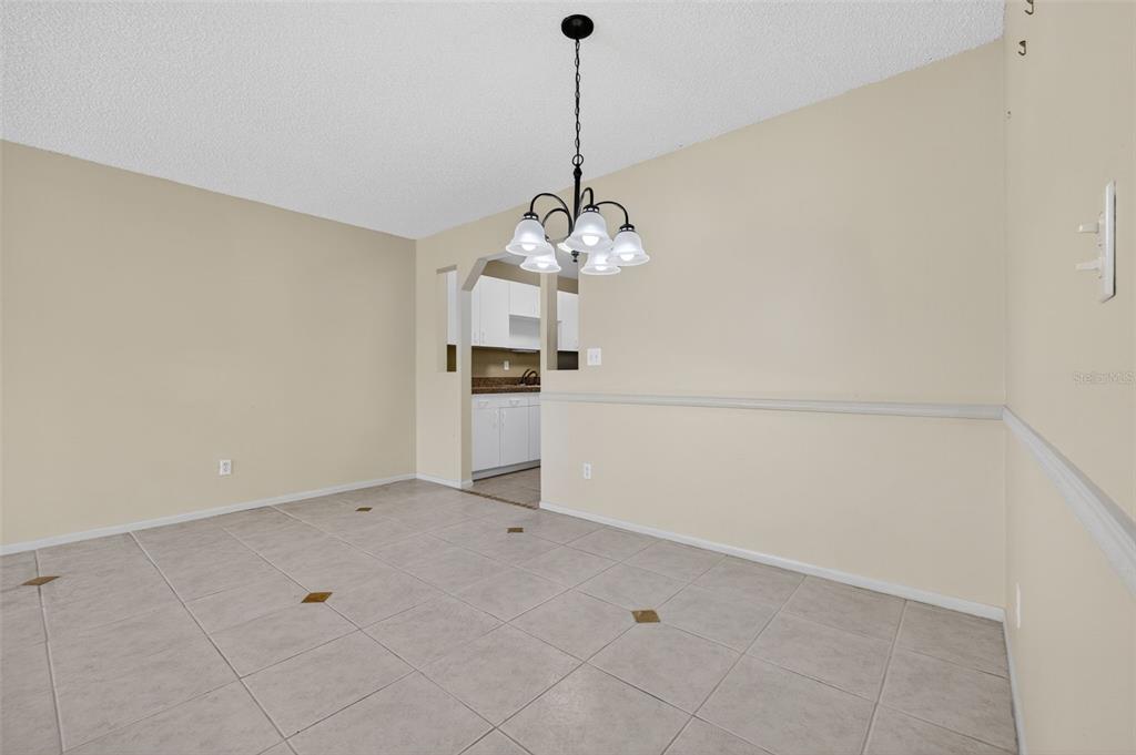 64 Winter Ridge Road, Unit 64 Winter Haven, FL 33881 - Photo 13 of 52 a view of a kitchen with dishwasher and white cabinets