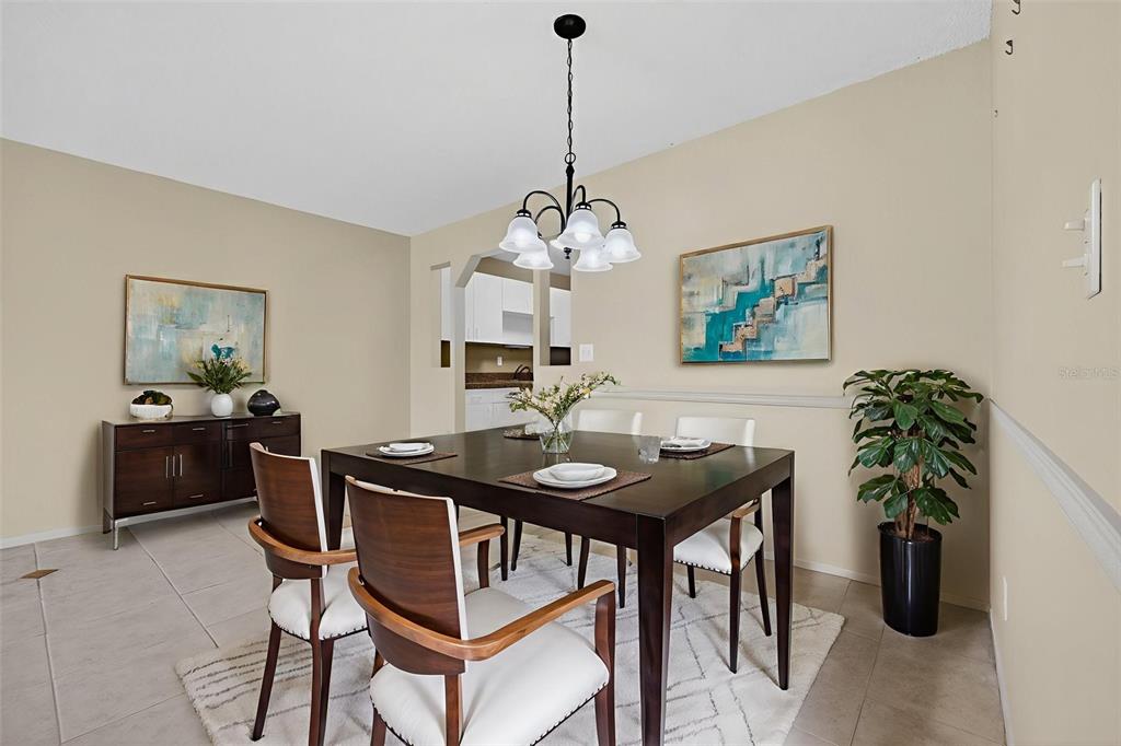 64 Winter Ridge Road, Unit 64 Winter Haven, FL 33881 - Photo 14 of 52 a view of a dining room with furniture and chandelier