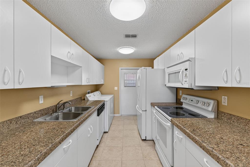 64 Winter Ridge Road, Unit 64 Winter Haven, FL 33881 - Photo 15 of 52 a kitchen with stainless steel appliances granite countertop a sink stove and cabinets