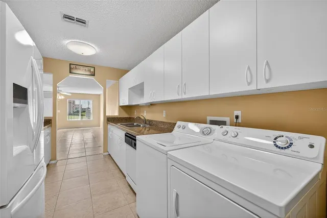 a kitchen that has a sink and a stove in it