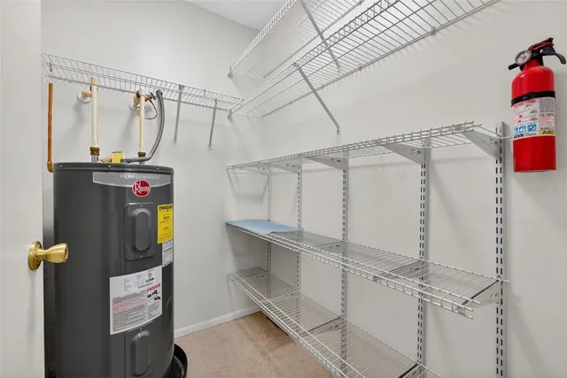 a utility room with cabinets and wooden floors