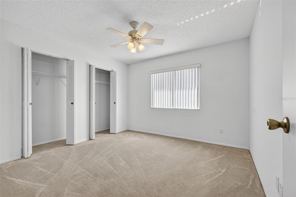64 Winter Ridge Road, Unit 64 Winter Haven, FL 33881 - Photo 19 of 52 an empty room with windows and fan