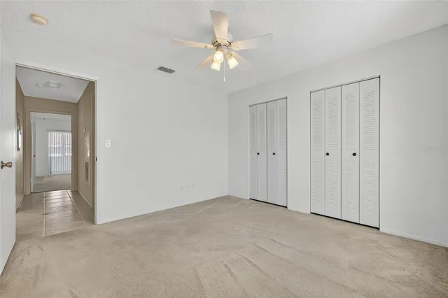 a view of an empty room with a fan