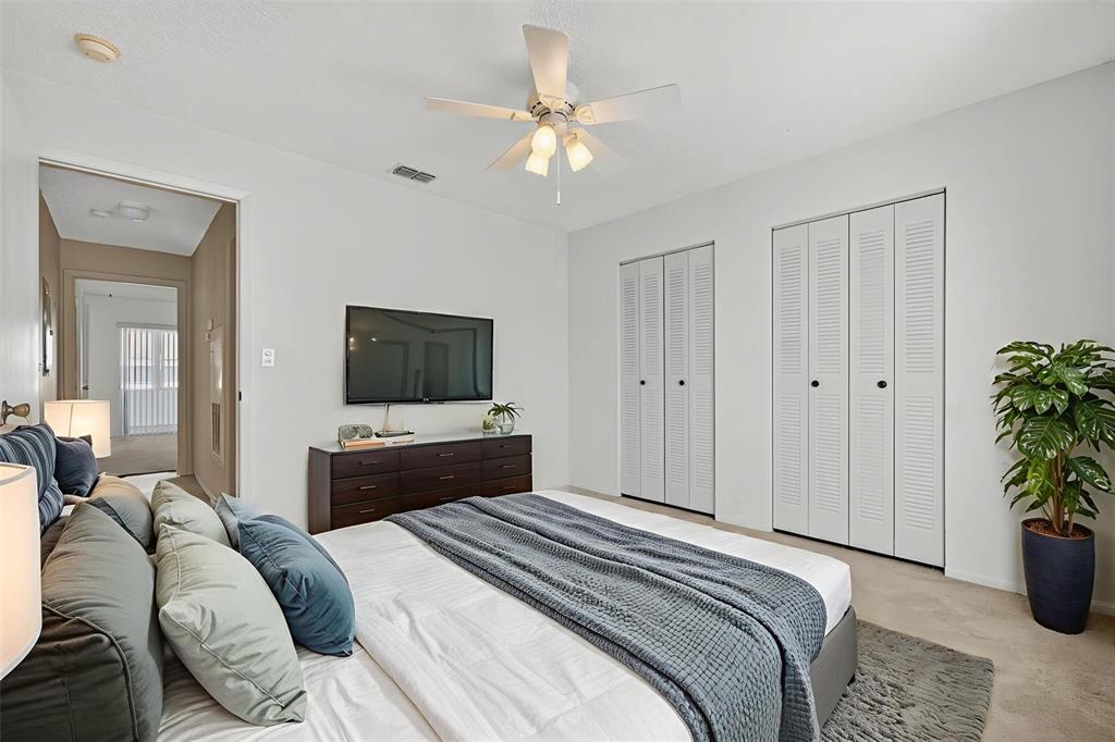 64 Winter Ridge Road, Unit 64 Winter Haven, FL 33881 - Photo 22 of 52 a bedroom with a bed and a potted plant