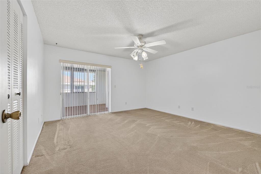 64 Winter Ridge Road, Unit 64 Winter Haven, FL 33881 - Photo 24 of 52 an empty room with windows and ceiling fan