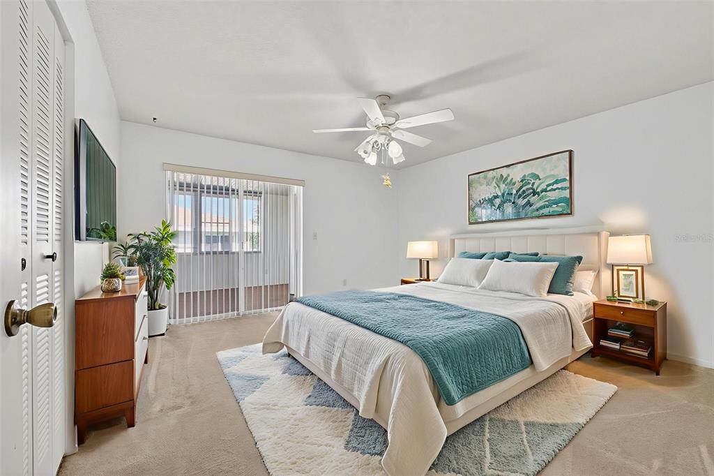 64 Winter Ridge Road, Unit 64 Winter Haven, FL 33881 - Photo 29 of 52 a spacious bedroom with a large bed a chandelier and windows