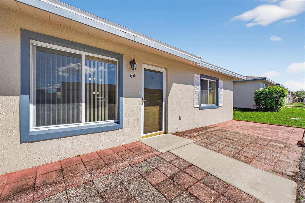 64 Winter Ridge Road, Unit 64 Winter Haven, FL 33881 - Photo 3 of 52 a front view of a house with a yard
