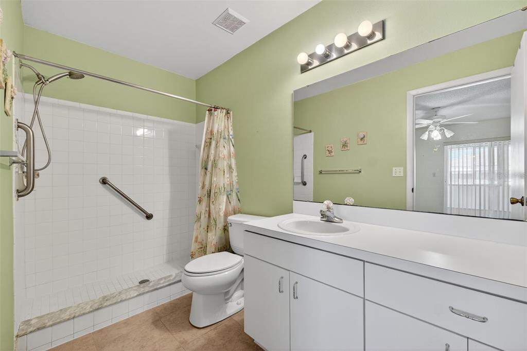 64 Winter Ridge Road, Unit 64 Winter Haven, FL 33881 - Photo 31 of 52 a bathroom with a sink toilet a mirror and shower
