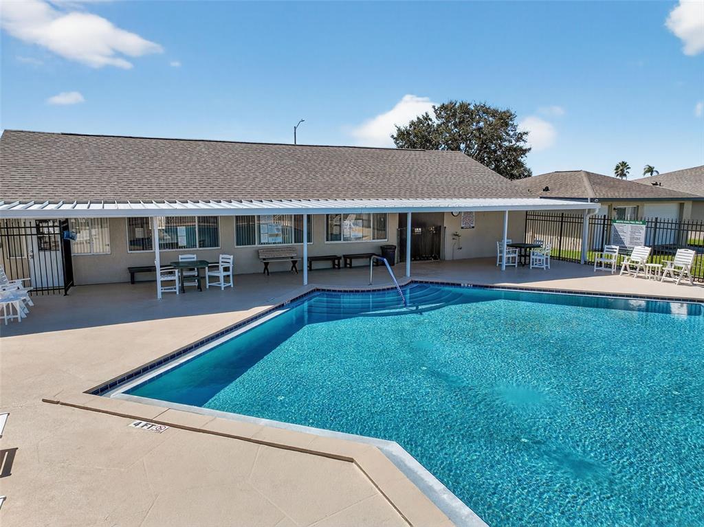 64 Winter Ridge Road, Unit 64 Winter Haven, FL 33881 - Photo 45 of 52 a view of a house with a backyard porch and sitting area