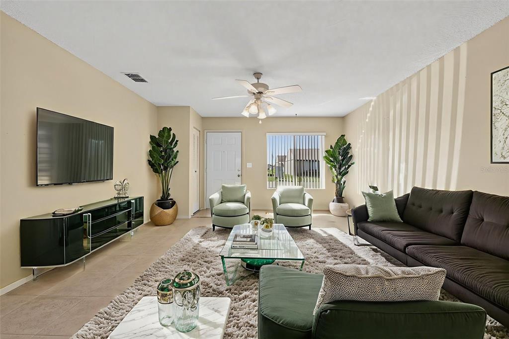 64 Winter Ridge Road, Unit 64 Winter Haven, FL 33881 - Photo 10 of 52 a living room with furniture and a flat screen tv