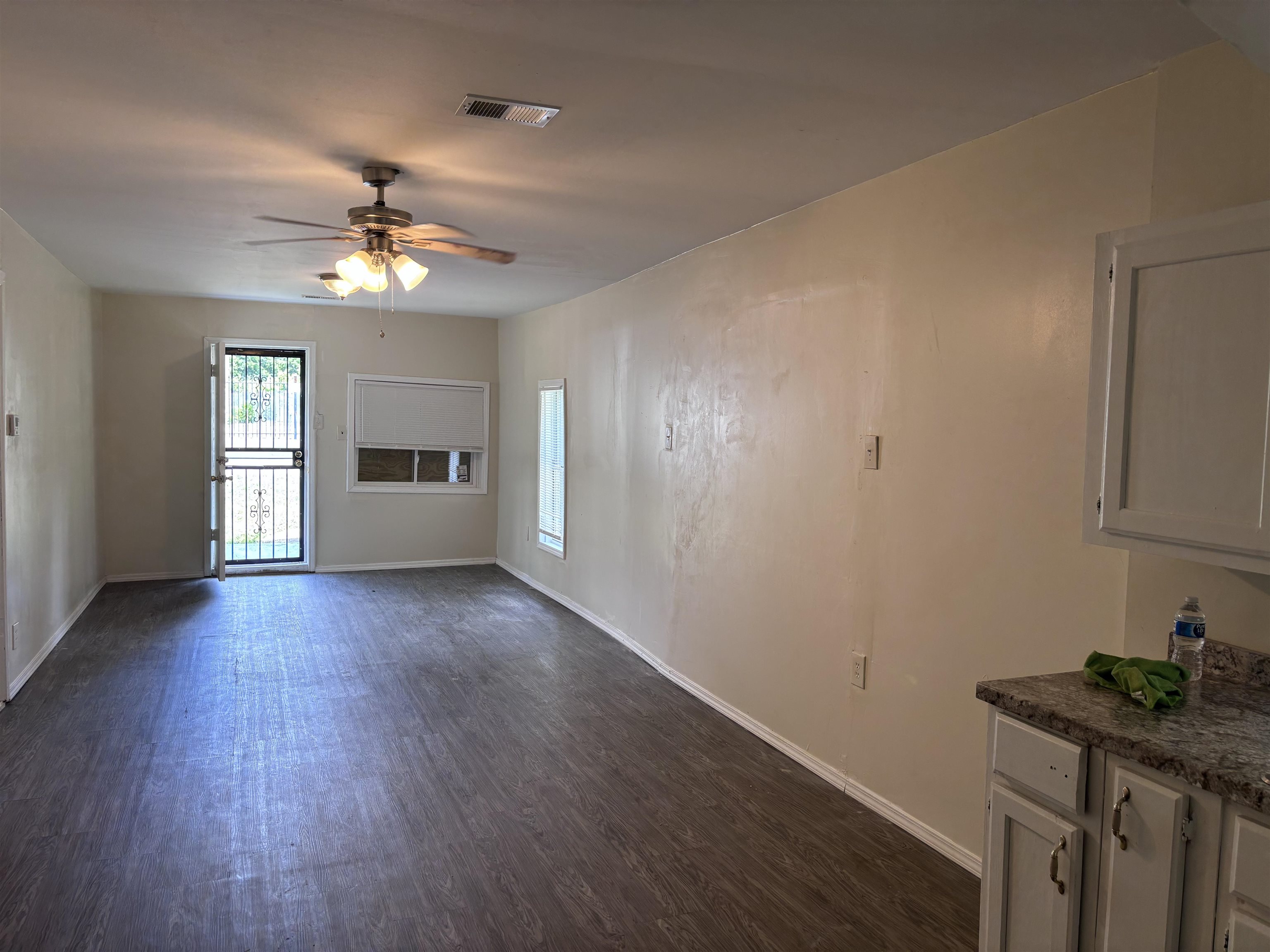 3589 Hawkins Mill Road Memphis, TN 38128 - Photo 6 of 9 a view of a livingroom with a fireplace a ceiling fan and wooden floor