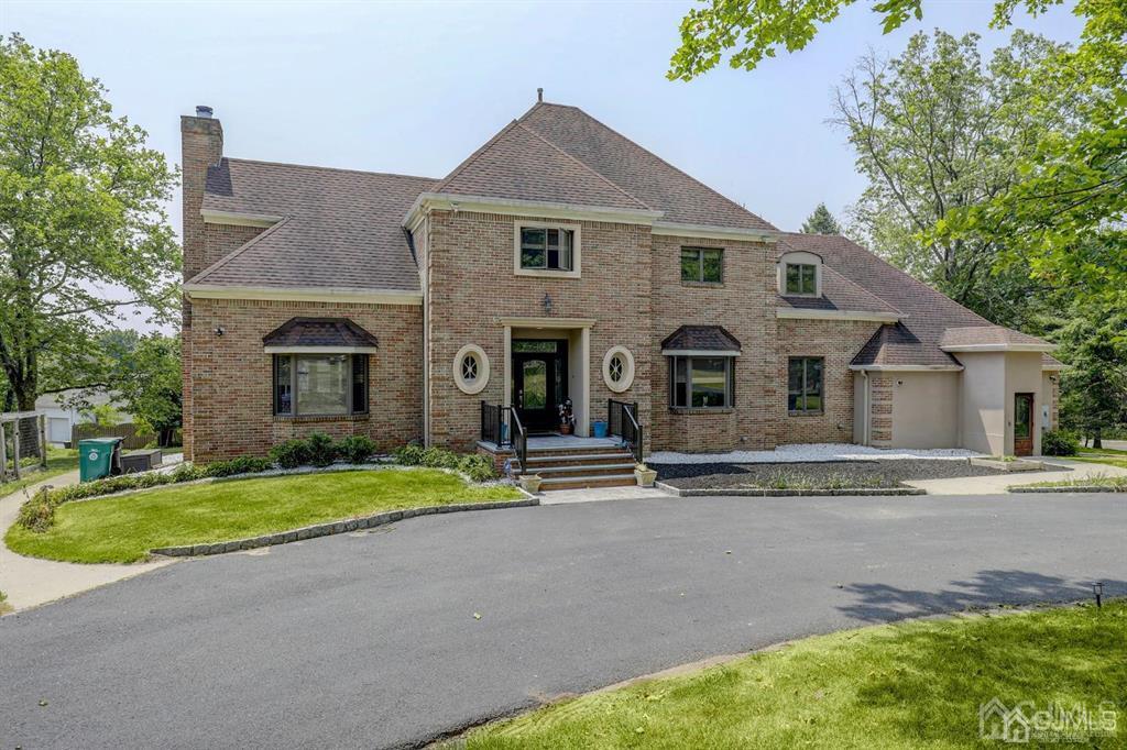 2 The Summit Holmdel, NJ 07733 - Photo 1 of 57 a front view of a house with a yard and garage