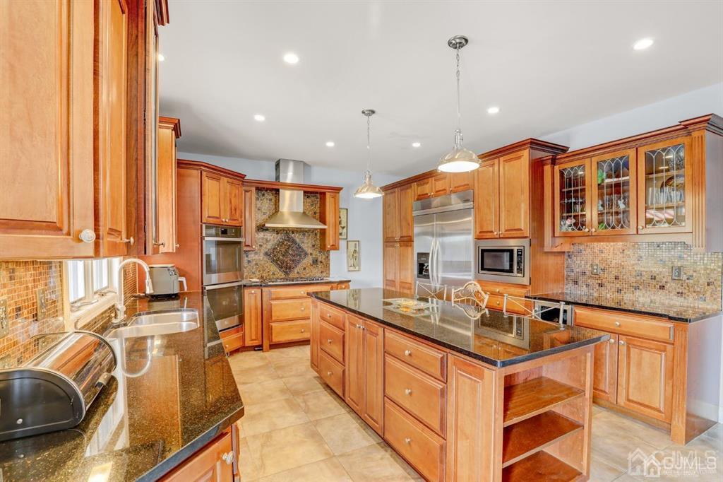 2 The Summit Holmdel, NJ 07733 - Photo 13 of 57 a kitchen with stainless steel appliances granite countertop a sink stove and cabinets