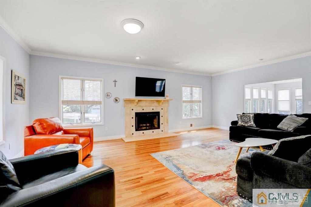 2 The Summit Holmdel, NJ 07733 - Photo 16 of 57 a living room with furniture a fireplace and a flat screen tv