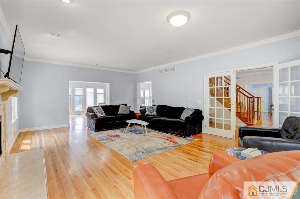 2 The Summit Holmdel, NJ 07733 - Photo 17 of 57 a living room with furniture and a wooden floor