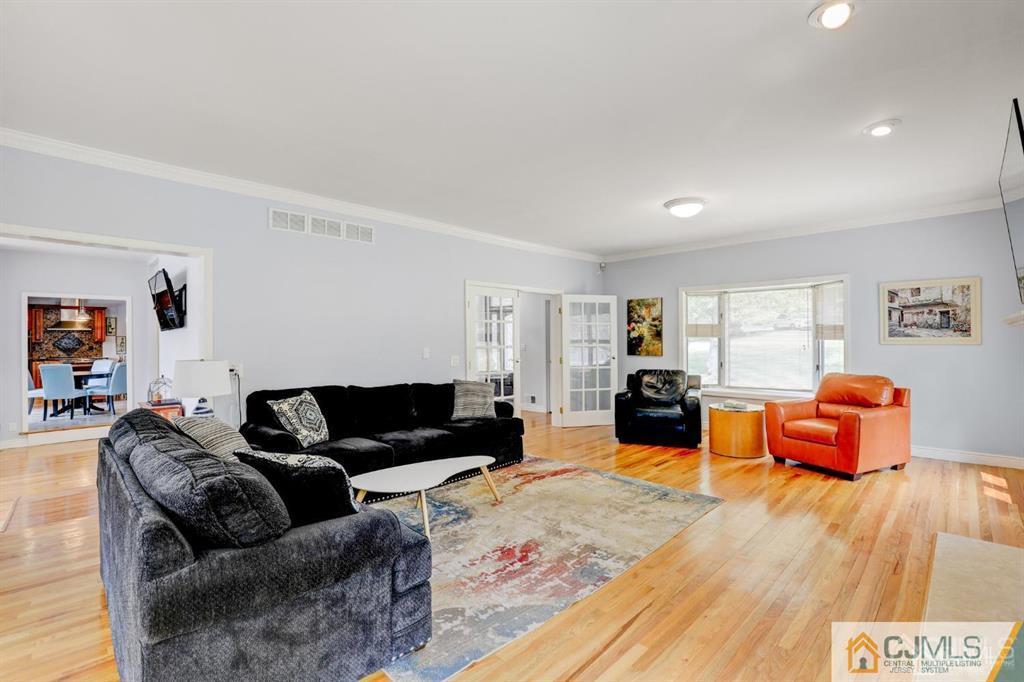 2 The Summit Holmdel, NJ 07733 - Photo 18 of 57 a living room with furniture and a wooden floor