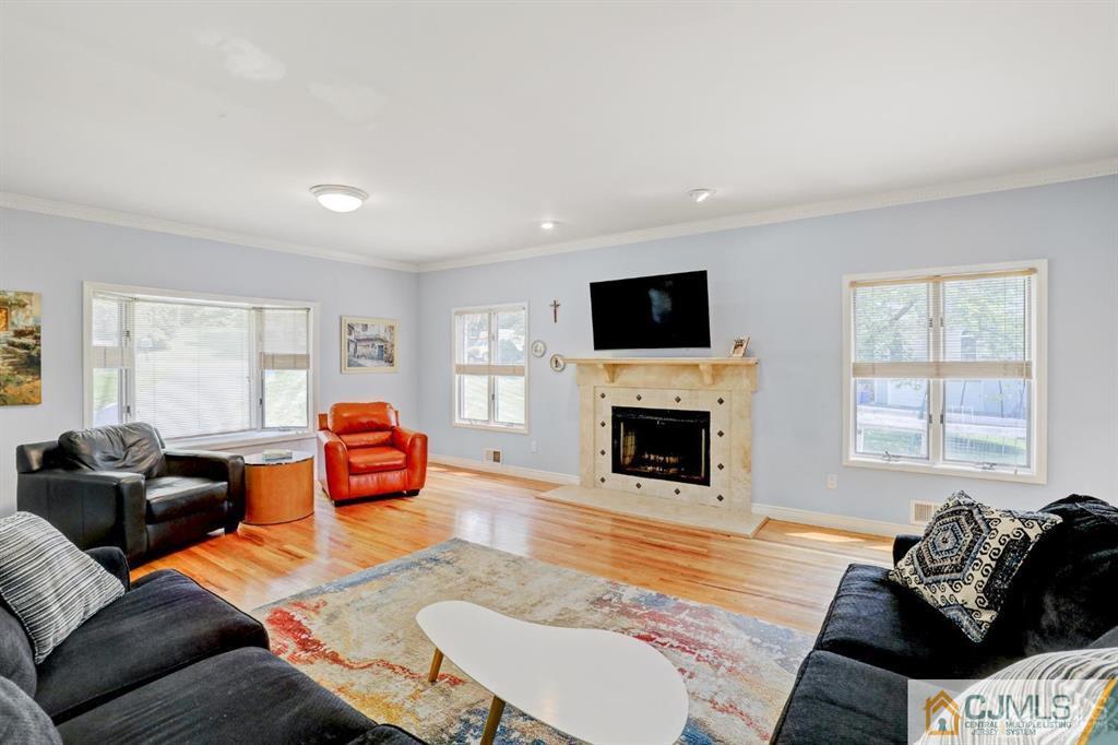 2 The Summit Holmdel, NJ 07733 - Photo 19 of 57 a living room with furniture a fireplace and a flat screen tv