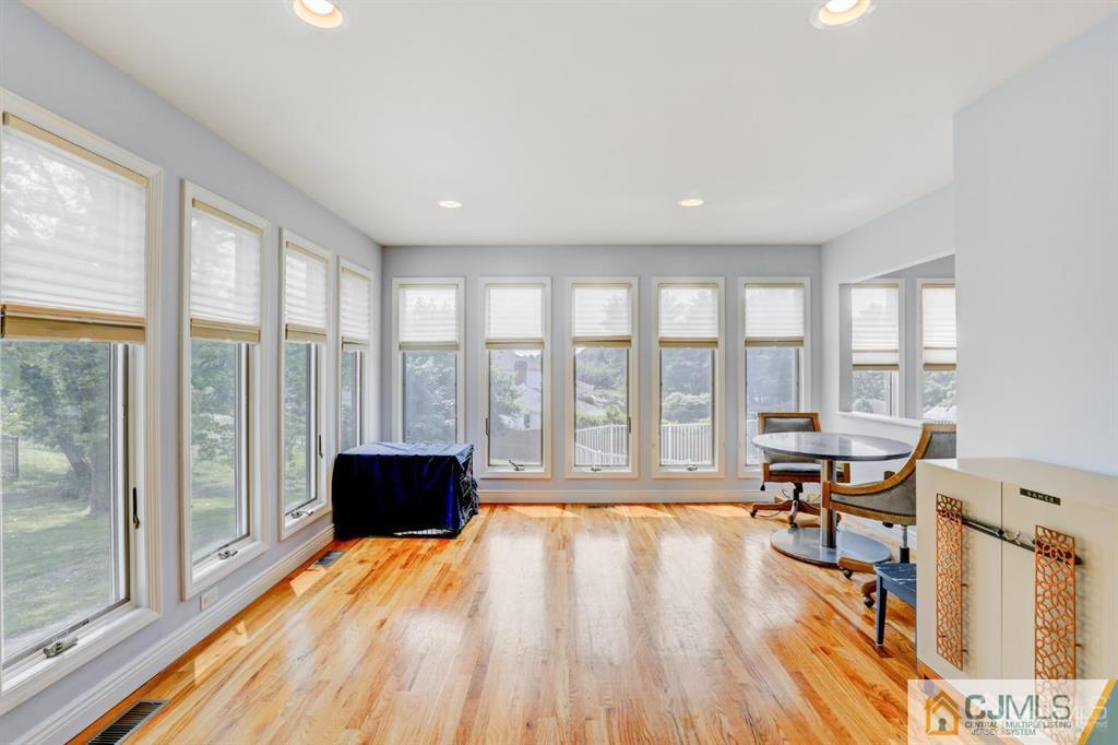 2 The Summit Holmdel, NJ 07733 - Photo 20 of 57 a living room with a large window and a wooden floor