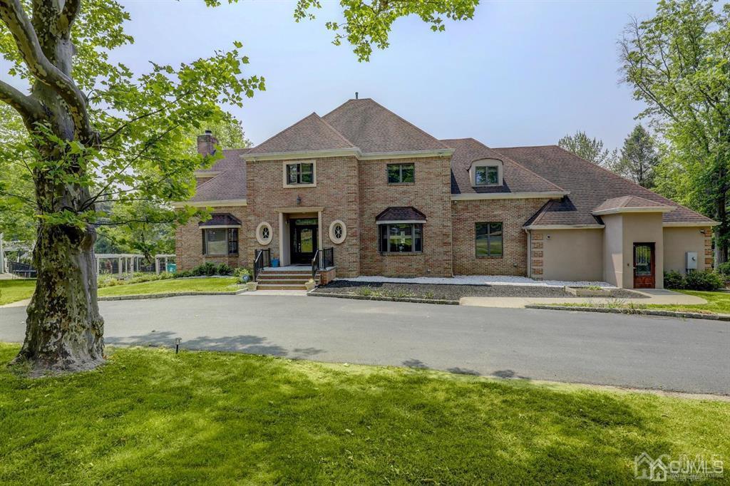 2 The Summit Holmdel, NJ 07733 - Photo 2 of 57 a front view of a house with a yard and garage