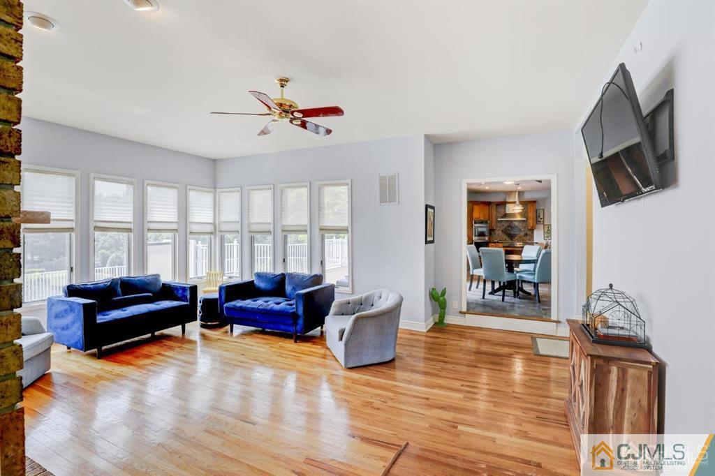2 The Summit Holmdel, NJ 07733 - Photo 21 of 57 a living room with furniture fireplace and a flat screen tv