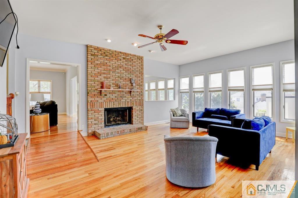 2 The Summit Holmdel, NJ 07733 - Photo 23 of 57 a living room with furniture a fireplace and a floor to ceiling window