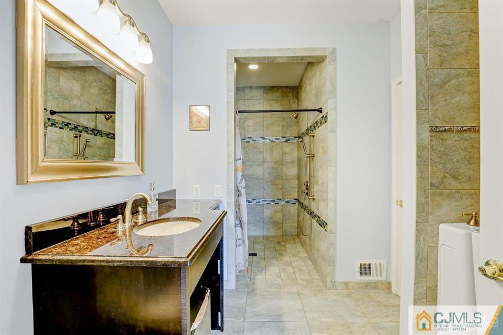 2 The Summit Holmdel, NJ 07733 - Photo 29 of 57 a bathroom with a sink and mirror