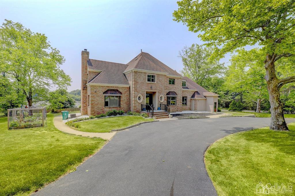 2 The Summit Holmdel, NJ 07733 - Photo 3 of 57 a front view of a house with yard and green space